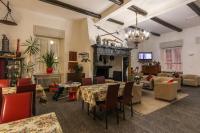 a living room with tables and chairs and a fireplace at Hotel Riviera in Melide