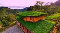 a house with a grass roof on a hill at Eco Lodge de Construção Natural com Vista Panorâmica in Nova Friburgo
