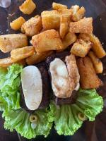 a plate of food with a sandwich and lettuce at Pousada Marajoara- Hotel Fazenda-Turismo de Aventura in Soure