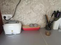 a toaster sitting on a counter next to a wall at Chez Mélanie in Marseille