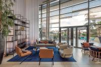 a living room with a couch and chairs at Hilton Evian Les Bains in Évian-les-Bains