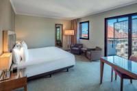 a hotel room with a large bed and a desk at Hilton Evian Les Bains in Évian-les-Bains