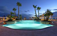 a large pool with palm trees in a resort at Hilton Ponce Golf & Casino Resort in Ponce