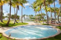 a large pool with palm trees in a park at Hilton Ponce Golf & Casino Resort in Ponce