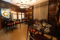 a restaurant with tables and chairs and a sign on the wall at Hilton Ponce Golf & Casino Resort in Ponce