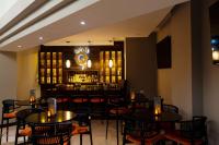 a restaurant with tables and chairs and a bar at Hilton Ponce Golf & Casino Resort in Ponce