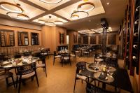 a restaurant with tables and chairs in a room at Hilton Ponce Golf & Casino Resort in Ponce