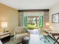 a living room with a desk and a chair at Hilton Ponce Golf & Casino Resort in Ponce