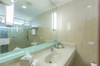 a bathroom with a sink and a large mirror at Hilton Ponce Golf & Casino Resort in Ponce