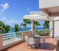 a balcony with a table and chairs and the ocean at Hilton Ponce Golf & Casino Resort in Ponce