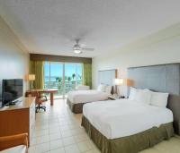 a hotel room with two beds and a television at Hilton Ponce Golf & Casino Resort in Ponce