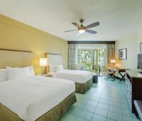 a hotel room with two beds and a television at Hilton Ponce Golf & Casino Resort in Ponce