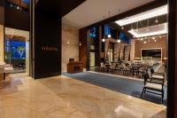 a restaurant with tables and chairs in a building at Hilton Monterrey Valle in Monterrey