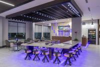 a large conference room with a large table and stools at Courtyard by Marriott Houston Heights/I-10 in Houston