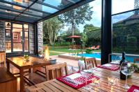 a patio with tables and chairs and a pool at Deerpark Luxury Stays in Nairobi