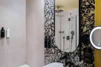 a bathroom with a shower with a mirror and a sink at Hôtel Riesner in Paris