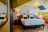 a bedroom with two beds and a skylight at Hôtel Riesner in Paris
