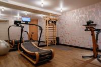 a room with a gym with exercise equipment and a treadmill at Hôtel Riesner in Paris
