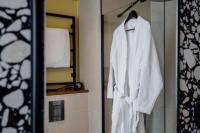 a white robe is hanging in a bathroom at Hôtel Riesner in Paris