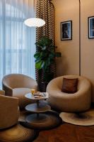 a living room with two chairs and a table at Hôtel Riesner in Paris