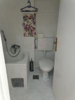 a small bathroom with a toilet and a bath tub at Flowers Apartment Tuzla in Tuzla