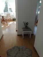 a living room with a table and a potted plant at Flowers Apartment Tuzla in Tuzla