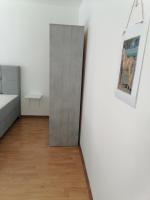 a room with a white wall and a mirror at Flowers Apartment Tuzla in Tuzla