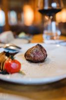 a plate with a piece of food on a table at Louis Hotel in Munich