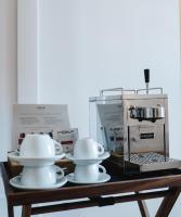 two dishes on a table next to a coffee maker at Louis Hotel in Munich