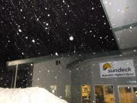 a snow storm in front of a building at Sundeck Hotel in Perisher Valley
