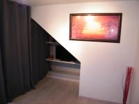 a hallway with a staircase with a painting on the wall at Chez Laurent et Sandrine in Chantraine