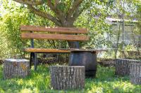 a wooden bench sitting in front of a tree at Lucija in Lovinac