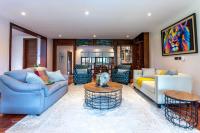 a living room with two couches and a table at Deerpark Luxury Stays in Nairobi