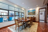 a dining room with a table and chairs at Deerpark Luxury Stays in Nairobi