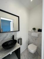 a bathroom with a black sink and a toilet at La maison de Giulia Menton in Menton