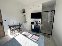 a kitchen with a table and a dining room at La maison de Giulia Menton in Menton