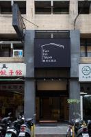 a group of motorcycles parked in front of a building at Fun Inn Taipei Hostel in Taipei