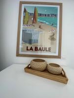 a picture of a beach with two baskets on a shelf at Studio with balcony - 2 min beach and AquaBaule in La Baule