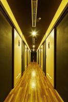 an empty hallway with wooden floors in an office building at Single inn- KAOHSIUNG LINSEN in Kaohsiung