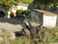 a statue of a machine in front of a building at Gîte Amour D&#39;ardèche in Saint-Sernin