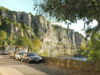 a group of cars parked next to a mountain at Gîte Amour D&#39;ardèche in Saint-Sernin