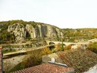 a view of a mountain with a bridge and buildings at Gîte Amour D&#39;ardèche in Saint-Sernin