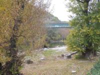 a bridge over a river with a bridge in the background at Gîte Amour D&#39;ardèche in Saint-Sernin