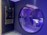 a bathroom with a round mirror and a shower at LES SECRETS ROOMS - BONNEVILLE - LOVE ROOM 130m2 - SPA PRIVATIF in Bonneville