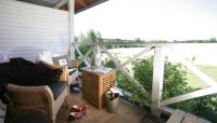 a screened in porch with a view of the water at Tertin Kartano in Mikkeli