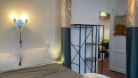 a bedroom with a bed with a light on the wall at Pied à terre Méditerranéen ! in Marseille