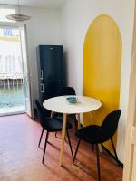 a table and chairs in a room with a refrigerator at Pied à terre Méditerranéen ! in Marseille