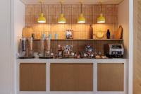 a kitchen with a counter with two lights above it at Hilton Garden Inn Marseille Provence Airport in Marignane
