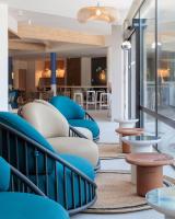 a lobby with blue chairs and tables at Hilton Garden Inn Marseille Provence Airport in Marignane