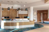 a lobby of a hotel with a reception desk at Hilton Garden Inn Marseille Provence Airport in Marignane